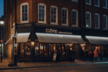 London, UK - November 23, 2021: Exterior of Cote Brasserie restaurant in Covent Garden, an area of Central London famous for its cafes and restaurants, on a dark winter evening.のeditorial素材