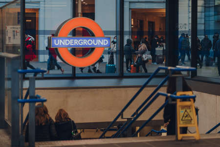 London, UK - January 01, 2022: London Underground sign at the entrance of King's Cross station, London, selective focus. London Underground is the oldest underground railway in the world.のeditorial素材
