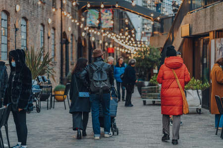 London, UK - January 01, 2022: People walking under the lights in Coal Drops Yard, a shopping destination and foodie hotspot near King's Cross St Pancras stations opened in 2018.のeditorial素材