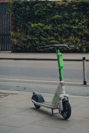 London, UK - January 01, 2022: Lime e-scooter on a street in King's Cross. Lime e-scooters are now available to hire across participating boroughs and private land developments in London.のeditorial素材