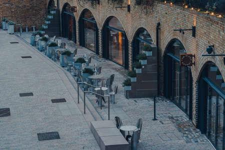 London, UK - January 01, 2022: Empty tables outside Tom Dixon Studio in Coal Drops Yard, a shopping...