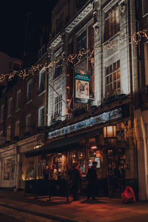 London, UK - November 23, 2021: People drinking outside The Two Brewers Greene King pub in Covent Garden, one of the most popular tourist areas in London, UK.のeditorial素材