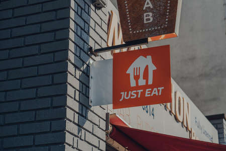 London, UK - January 30, 2022: Just Eat sign outside a restaurant in Camden, London. Just Eat is a company that enables food to be delivered from restaurants that do not offer delivery.のeditorial素材