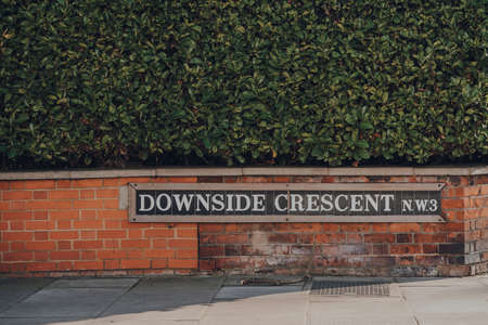 Tiled street name sign on Downside Crescent, Belsize park, North London, UK.