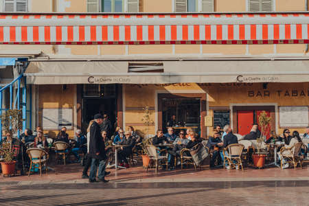 Nice, France - March 10, 2022: People sitting at the outdoor table of La Civette du Cours restaurant on Cours Saleya, a street in the Old Town of Nice best known for its daily open-air markets.のeditorial素材