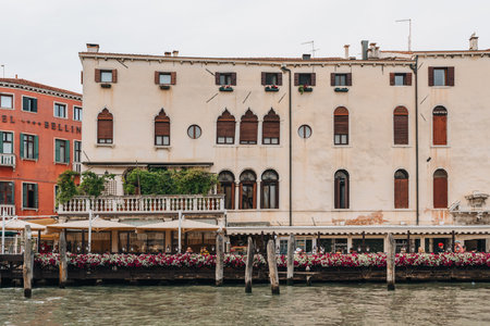 Venice, Italy - May 22, 2022: People at the outdoor tables of Ristorante Roma by Grand Canal in Venice, a popular tourist destination in Italy for its uniqueness and architecture.のeditorial素材