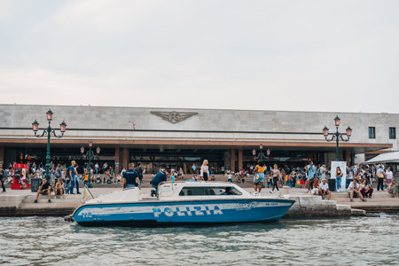 Venice, Italy - May 22, 2022: Police boat on Grand Canal outside Santa Lucia train station in...