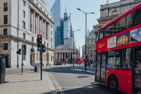 London, UK - August 26, 2022: Red double decker bus at a traffic light by the Bank Underground station in the City of London, Londons famous financial district.のeditorial素材