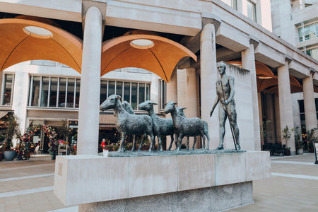 London, UK - August 26, 2022: Shepherd and Sheep outdoor bronze sculpture by Elisabeth Frink in Paternoster Square near St Paul's Cathedral in London, United Kingdom.のeditorial素材