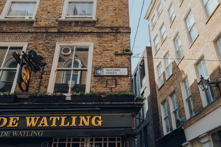 London, UK - August 26, 2022: Low angle view of a street name sign on a building on Watling Street in the City of London, London's famous financial district.のeditorial素材