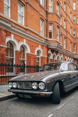 London, UK - September 1, 2022: Bristol 411 parked in front of red brick house in London. The Bristol 411 is a classic car which was built by the British manufacturer Bristol Cars from 1969 to 1976.のeditorial素材
