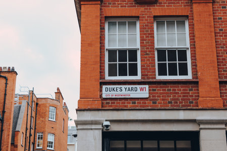 London, UK - September 1, 2022: Street name sign on a red brick building in Duke's Yard, City of Westminster, a borough that occupies much of the central area of London including most of the West End.のeditorial素材