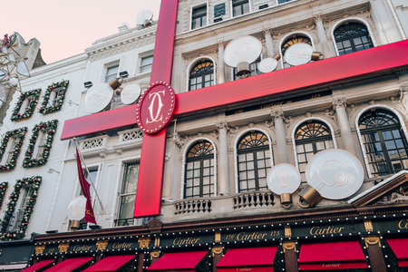 London, UK - December 26, 2022: Christmas bow decorations on the facade of the Cartier store on New Bond Street, one of the most famous streets for luxury shopping in London.のeditorial素材