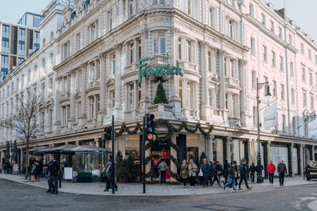 London, UK - December 26, 2022: Christmas decorated entrance of Fenwick mall on Bond Street, one of the most famous streets for luxury shopping in London, people walking past.のeditorial素材