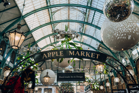 London, UK - December 26, 2022: Apple Market sign amongst Christmas decorations in Covent Garden Market, one of the most popular tourist sites in London, UK.のeditorial素材
