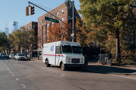 New York, USA - November 21, 2022: USPS truck on 6th Street in Manhattan. The US Postal Service is an independent agency of the United States federal government responsible for postal service.のeditorial素材