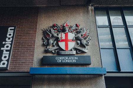London, UK - February 02, 2023: Sign for The City of London Corporation, the municipal governing body of the City of London, on a wall of a building in Barbican.のeditorial素材