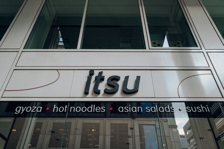 London, UK - February 02, 2023: Sign outside Itsu restaurant in the City of London. Itsu is a British chain of East Asian-inspired fast food shops and restaurants, and a grocery company.のeditorial素材