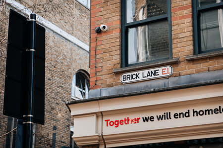 London, UK - February 09, 2023: Street name sign on a building in Brick Lane, the heart of the Londons Bangladeshi-Sylheti community.のeditorial素材