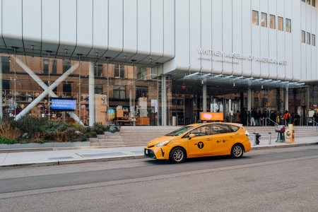 New York, USA - November 21, 2022: Yellow taxi waiting in front of  Whitney Museum in Manhattan New York, USA. New York is the third most traffic congested city in the world.のeditorial素材