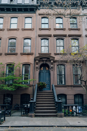 New York, USA - November 21, 2022: Exterior of a traditional house with a stoop in West Village, a charming area of Manhattan famous for its shops and restaurants.のeditorial素材