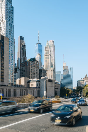 New York, USA - November 22, 2022: View of skyscrapers in Financial District from Brooklyn Bridge, New York, cars driving in front, motion blur.のeditorial素材