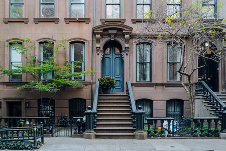 New York, USA - November 21, 2022: Exterior of a traditional house with a stoop in West Village, a charming area of Manhattan famous for its shops and restaurants.のeditorial素材