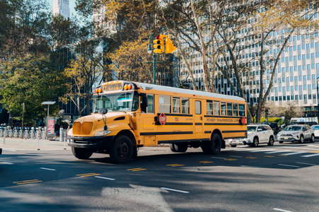 New York, USA - November 22, 2022: Yellow school bus on a road in Manhattan, New York. The City of New York provides student with free transportation to and from school.のeditorial素材