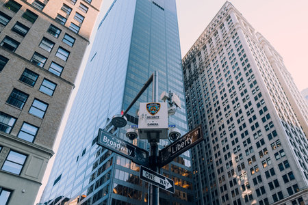 New York, USA - November 25, 2022: NYPD camera above street name signs on the corner of Broadway and Liberty st., one of over 15,000 NYPD surveillance cameras in Manhattan, Brooklyn and the Bronx.のeditorial素材
