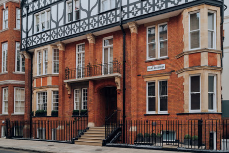 London, UK - February 21, 2023: Exterior or a red brick building with Tudor styling on Hans Crescent in Kensington and Chelsea, an affluent area of West London favoured by celebrities.のeditorial素材