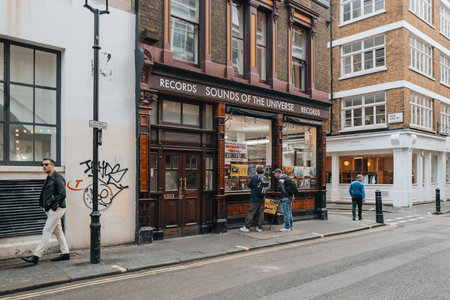 London, UK - April 13, 2023: Exterior of the Sounds of the Universe record shop in Soho associated with Soul Jazz Records, an independent record label, people walking past.のeditorial素材