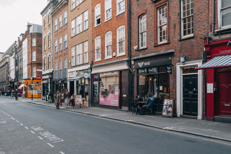 London, UK - April 13, 2023: Street view of restaurants in Soho, an area of London famous for LGBTQ+ bars, restaurants and clubs.のeditorial素材