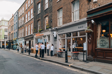London, UK - April 13, 2023: Restaurants and cafes in Soho, an area of London famous for LGBTQ+ bars, restaurants and clubs.のeditorial素材