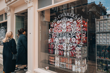 London, UK - April 13, 2023: Sign celebrating coronation of King Charles III in the window of Liberty, a department store in Oxford Circus famous for Liberty designs, people entering on background.のeditorial素材