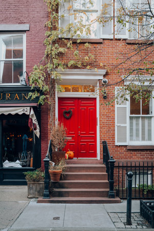 November 23, 2022 - New York, USA: Bright red front door on a house in West Village, a neighbourhood in Manhattan with an old-school residential feel.のeditorial素材