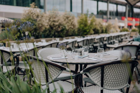 Set outdoor restaurant tables and chairs in London, UK, selective focus.の写真素材