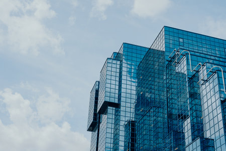 London, UK - July 06, 2023: Low angle view of The Northern and Shell Building, a landmark office building with an iconic blue glazed elevation on the north side of the River Thames.のeditorial素材