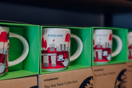 London, UK - July 06, 2023: Collectable England mugs from You Are Here collection on sale inside Starbucks cafe in London. Starbucks is a famous American coffeehouse chain.のeditorial素材