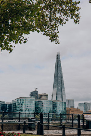 London, UK - July 06, 2023: View of South Thames riverside and The Shard through the trees on the North bank. The Shard is are one of the most popular landmarks in London.のeditorial素材