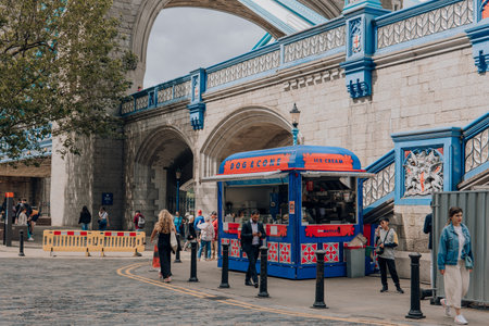 London, UK - July 06, 2023: Dog and Cone ice-cream and hot dog stall on Thames riverside by Tower Bridge, one of London's top tourist attractions.のeditorial素材