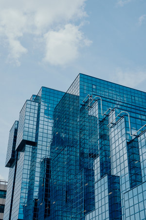 London, UK - July 06, 2023: Low angle view of The Northern and Shell Building, a landmark office building with an iconic blue glazed elevation on the north side of the River Thames.のeditorial素材