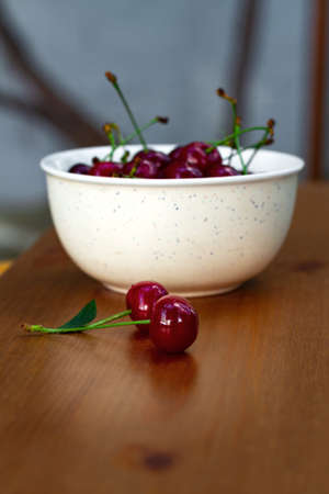 Fresh ripe juicy organic cherries on a wooden table
