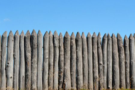 Wooden fence on a blue sky background.の写真素材