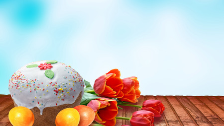 Festive Easter cake and spring bright flowers.