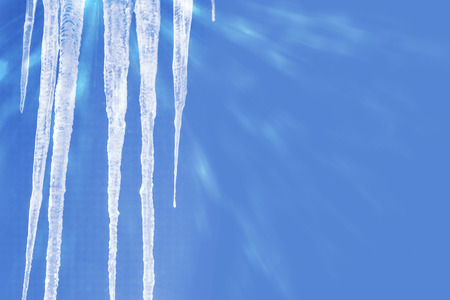White icicles against the blue winter sky.の写真素材