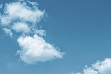 Blurred background. Blue sky and white fluffy clouds.