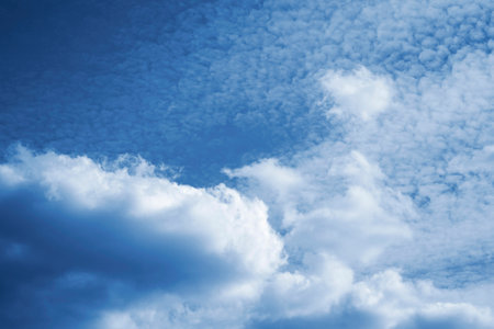 Blurred background. Blue sky and white fluffy clouds.の写真素材