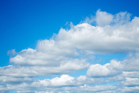 Blurred background. Blue sky and white fluffy clouds.の写真素材