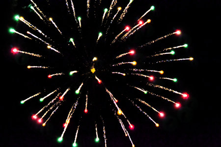 Greeting card Happy New Year. fireworks on a black background, golden sparks and firecrackers.の写真素材