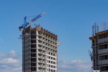 Construction of a house in the city. Cranes build a skyscraperのeditorial素材